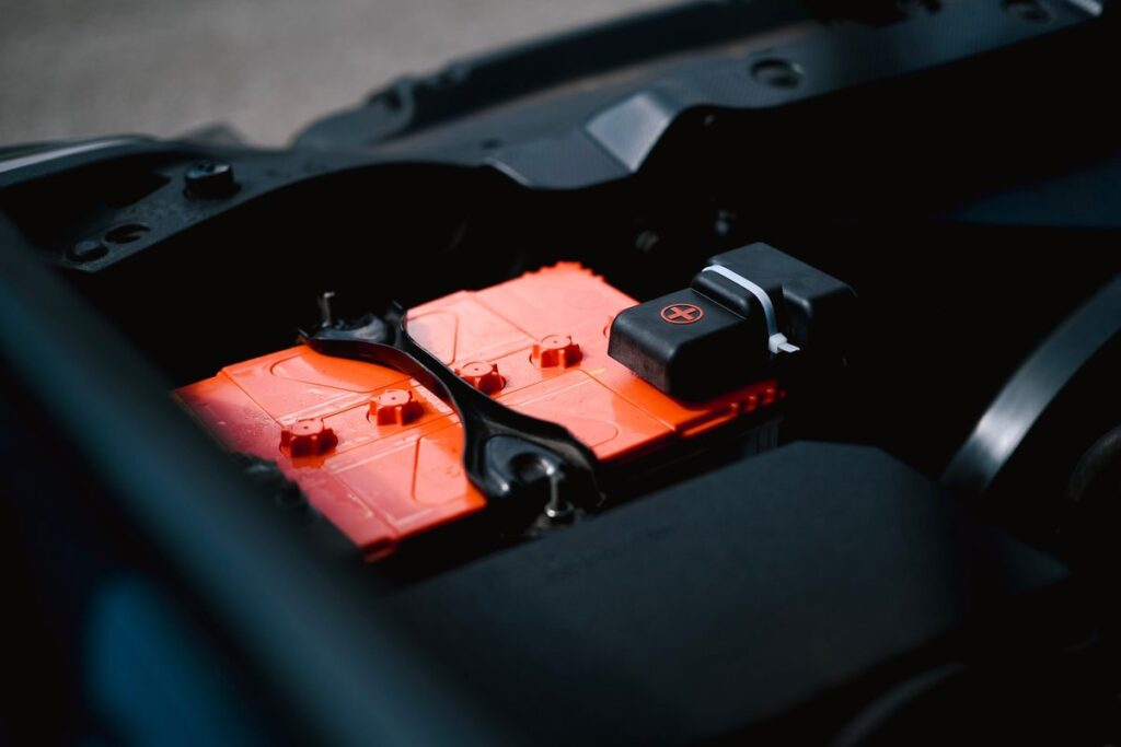 Car battery under the hood during auto electrical repair service in Dubai at Shabab Al Lisaili Auto Electric Repair