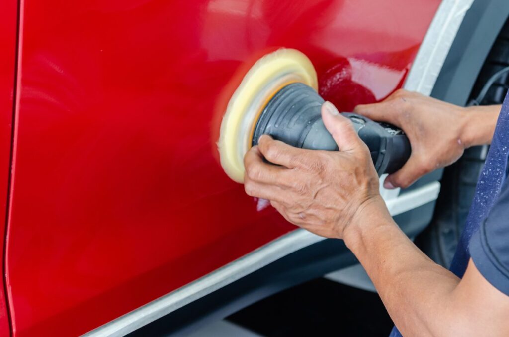 Technician polishing car paint during dent and paint repair service in Dubai at Shabab Al Lisaili Auto Electric Repair